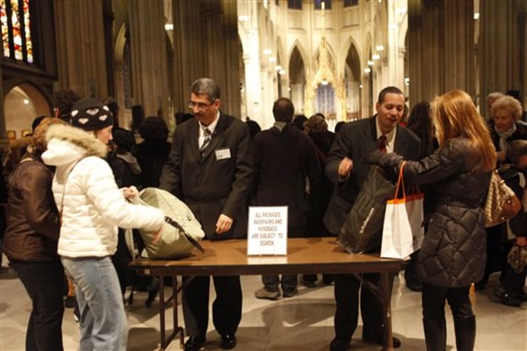 In this Dec. 2, 2010 photo, security personnel inspect packages of visitors to St. Patrick's Cathedral, in New York. As the holiday tourist season begins in the Big Apple, there are reminders everywhere of how being the country?s main target for terrorism has gradually changed this city. (AP Photo/Mary Altaffer)